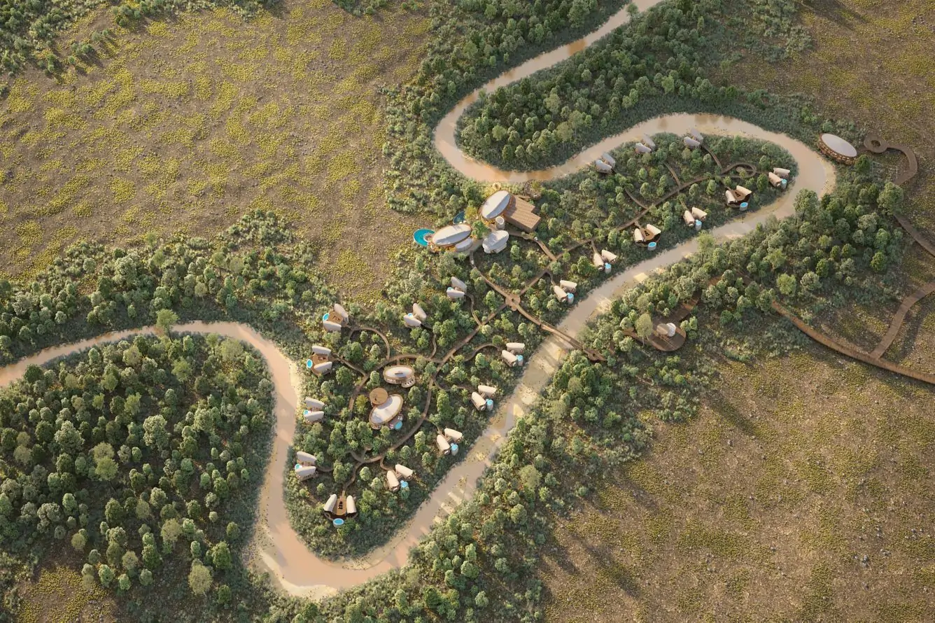 The Ritz-Carlton Masai Mara Safari Camp elevated among trees with river views