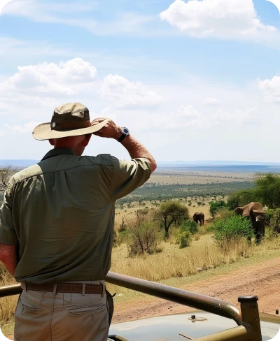 Safari vehicle in the Kenyan savannah with wildlife in the background